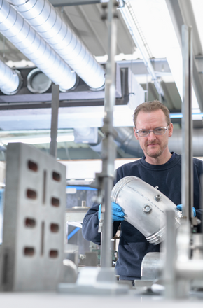 Man engineer in manufacture - Getty Images